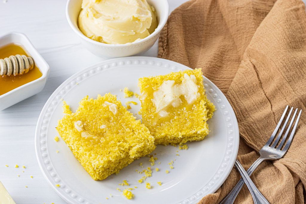 melted butter on cornbread on a white plate