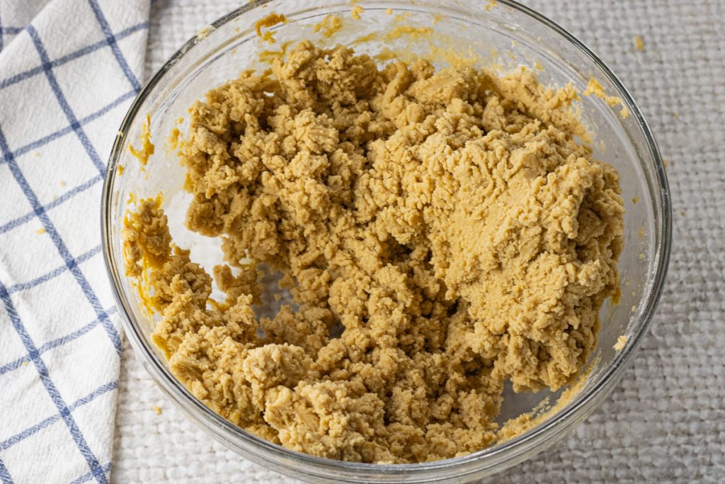 peanut butter cookie dough in a glass mixing bowl