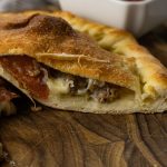 calzone cut in half with fillings coming out