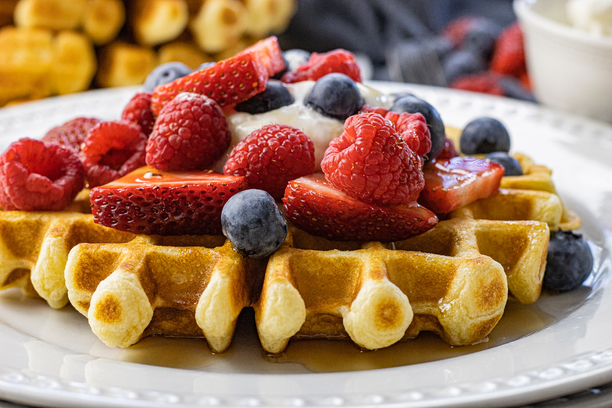 waffle topped with berries and whipped cream