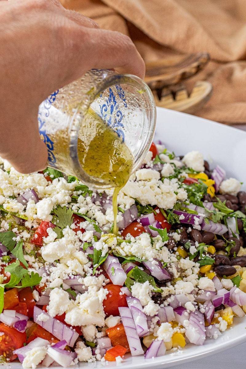 pouring on salad dressing