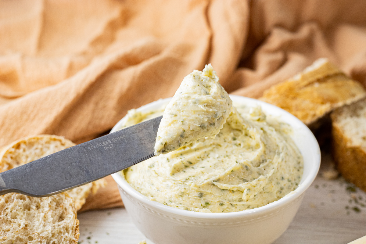 knife with garlic butter on it