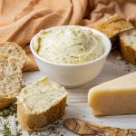 bread topped with garlic butter and a bowl of garlic butter