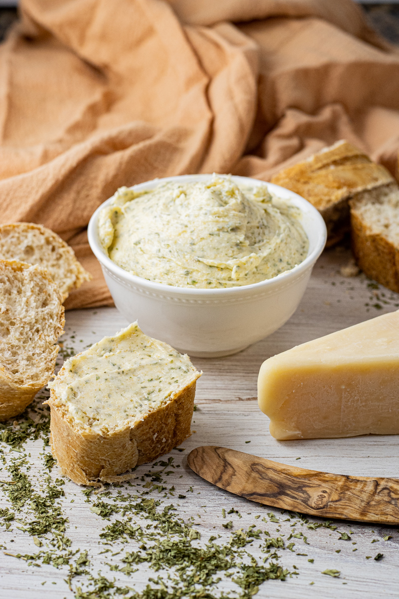 bowl of butter made with garlic, cheese and herbs