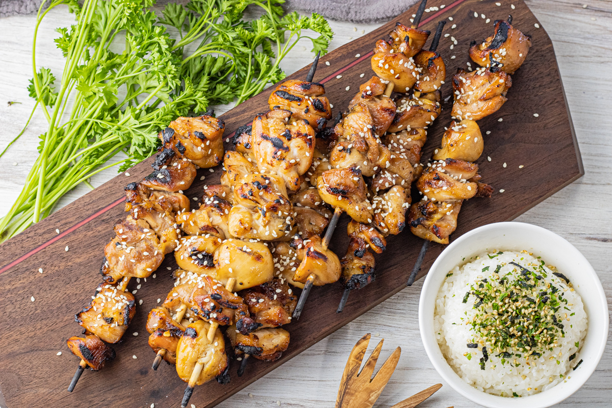chicken teriyaki skewers on a wooden cutting board