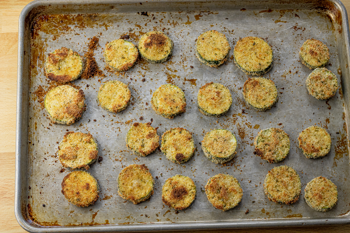 crispy baked zucchini rounds on a baking sheet