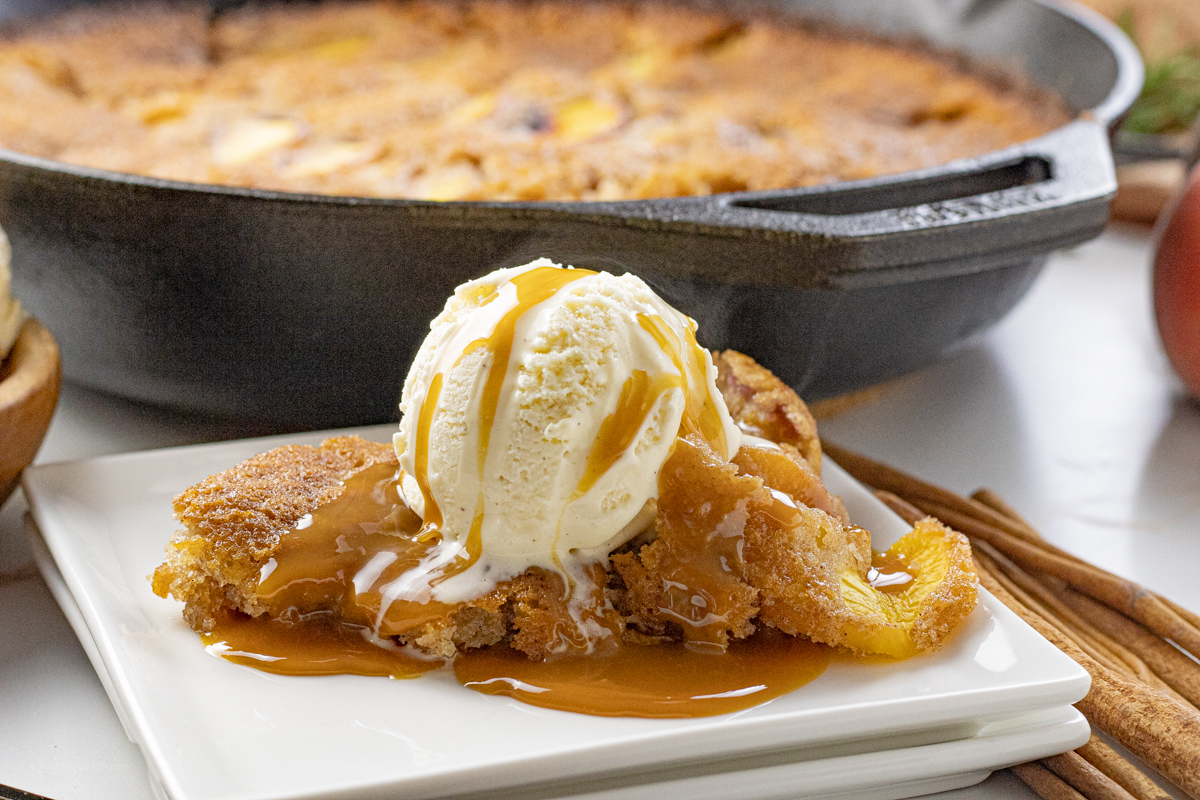 ice cream and caramel on top of peach cobbler