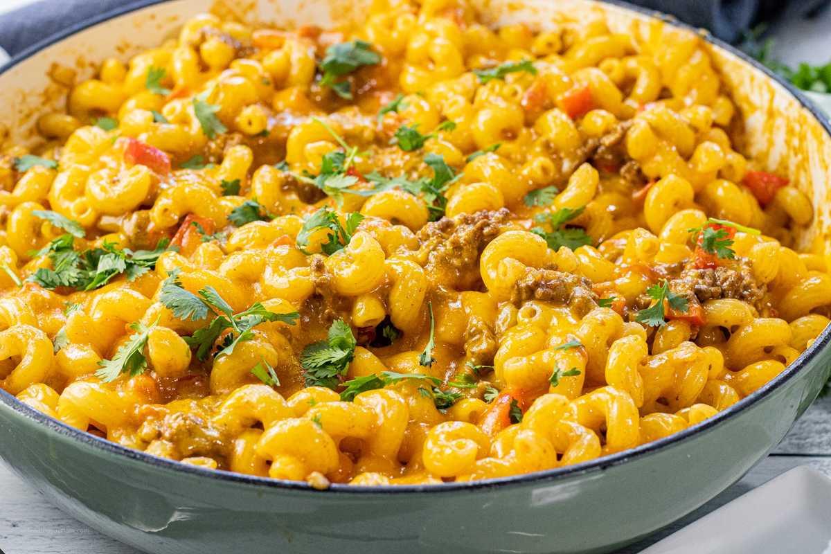 up close of twisty, cheese pasta with ground beef and cilantro