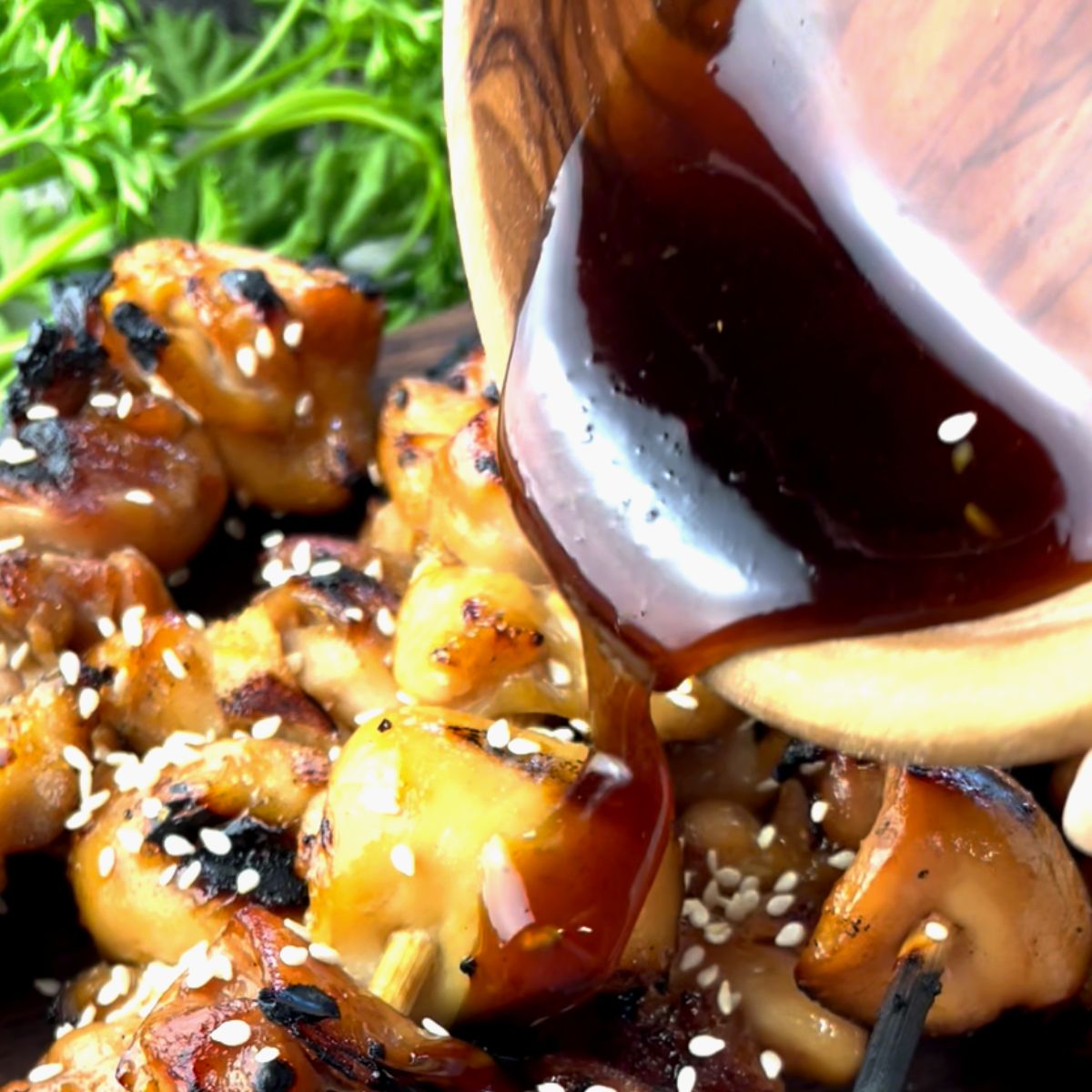 pouring teriyaki sauce onto chicken