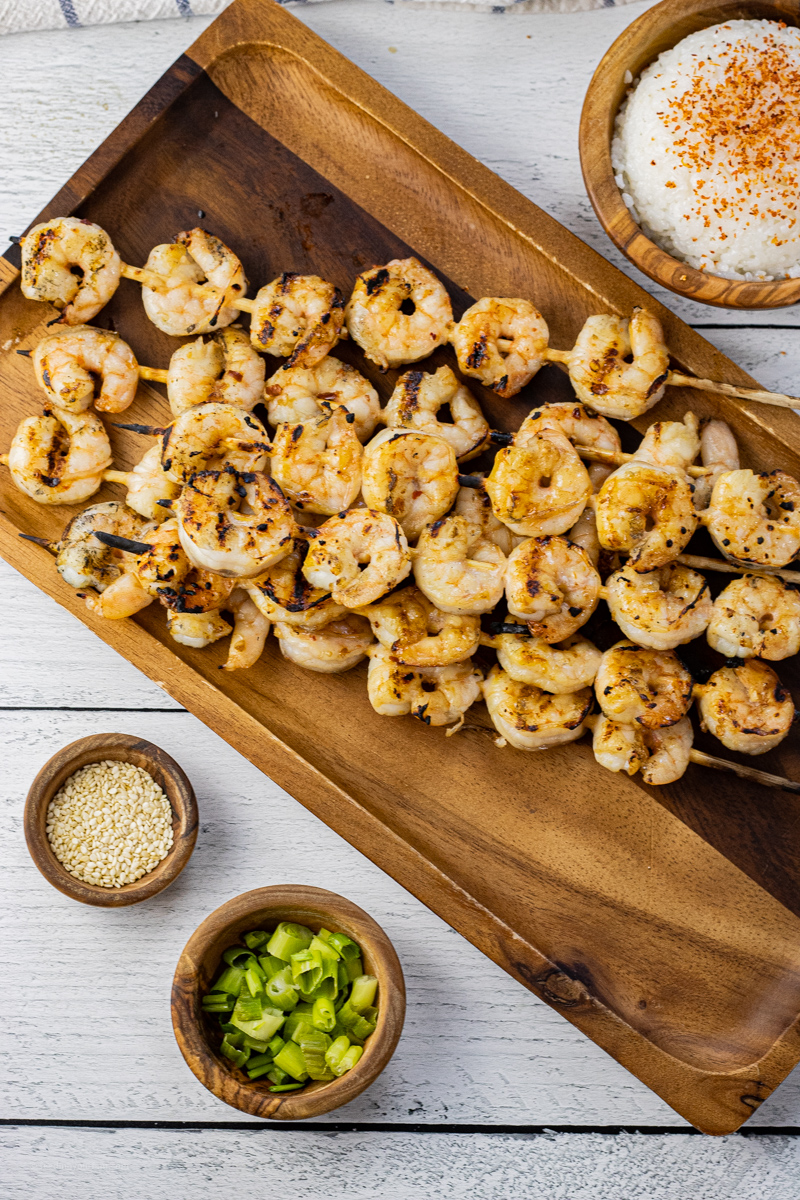 grilled shrimp skewers on a wooden platter