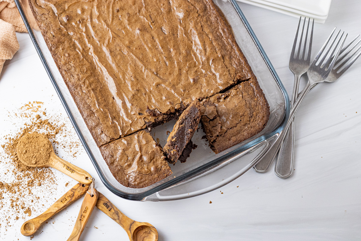 pan of chocolate brownies with one square brownie turned on its side to show the center