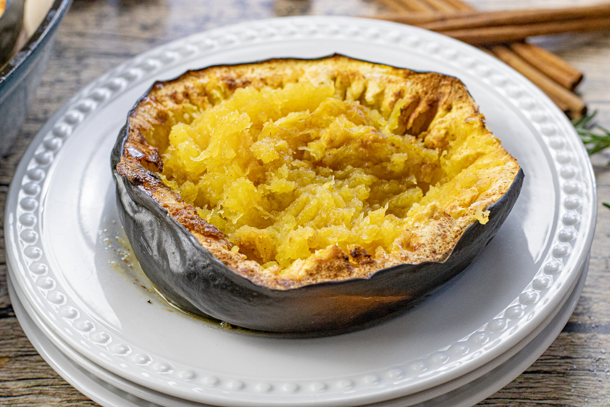 cooked half of acorn squash on a white plate