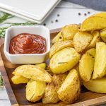 sliced roasted golden potatoes with rosemary and garlic