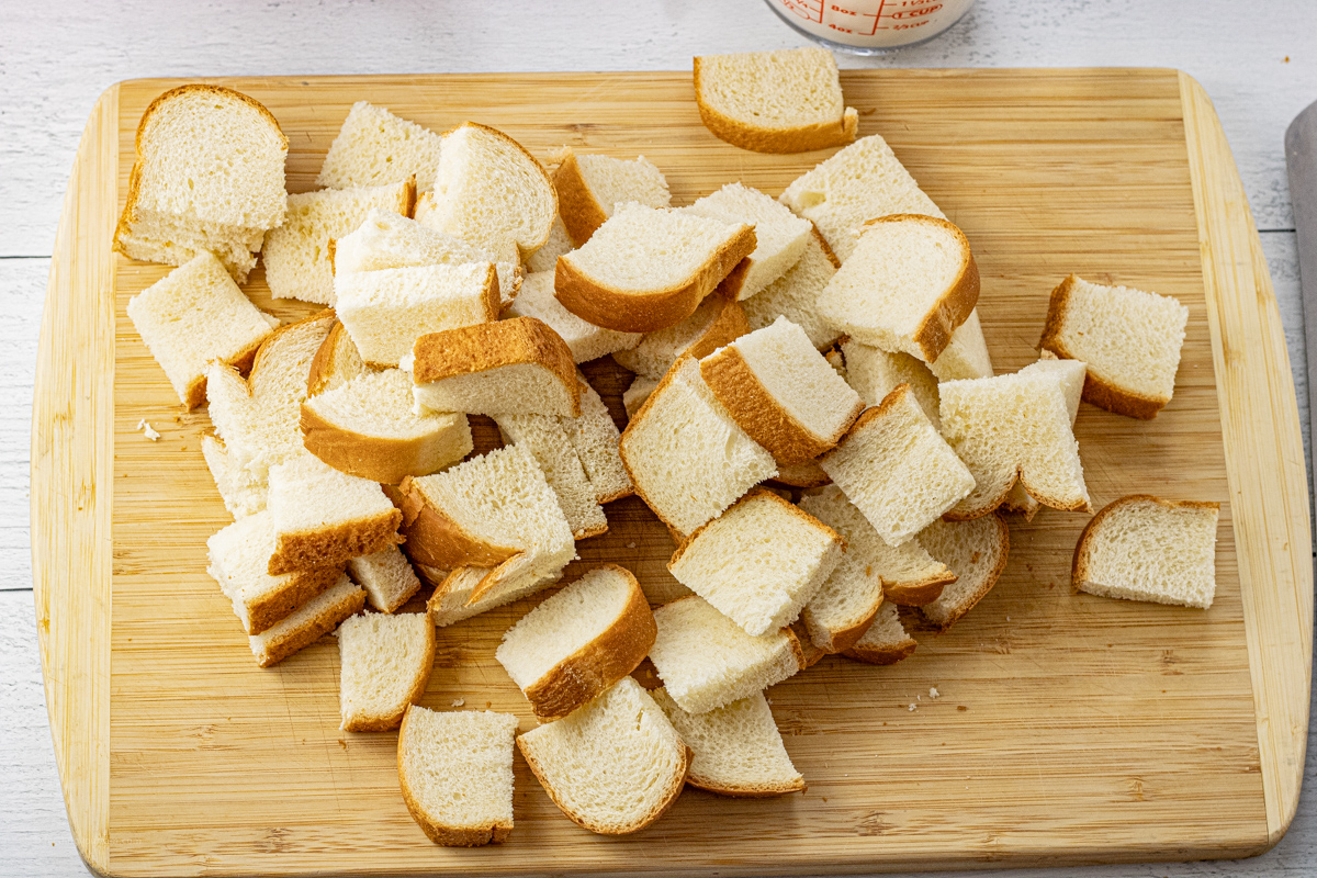 pieces of sliced white bread on a wooden cutting board