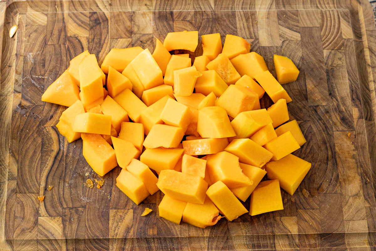 cubes of butternut squash on a cutting board