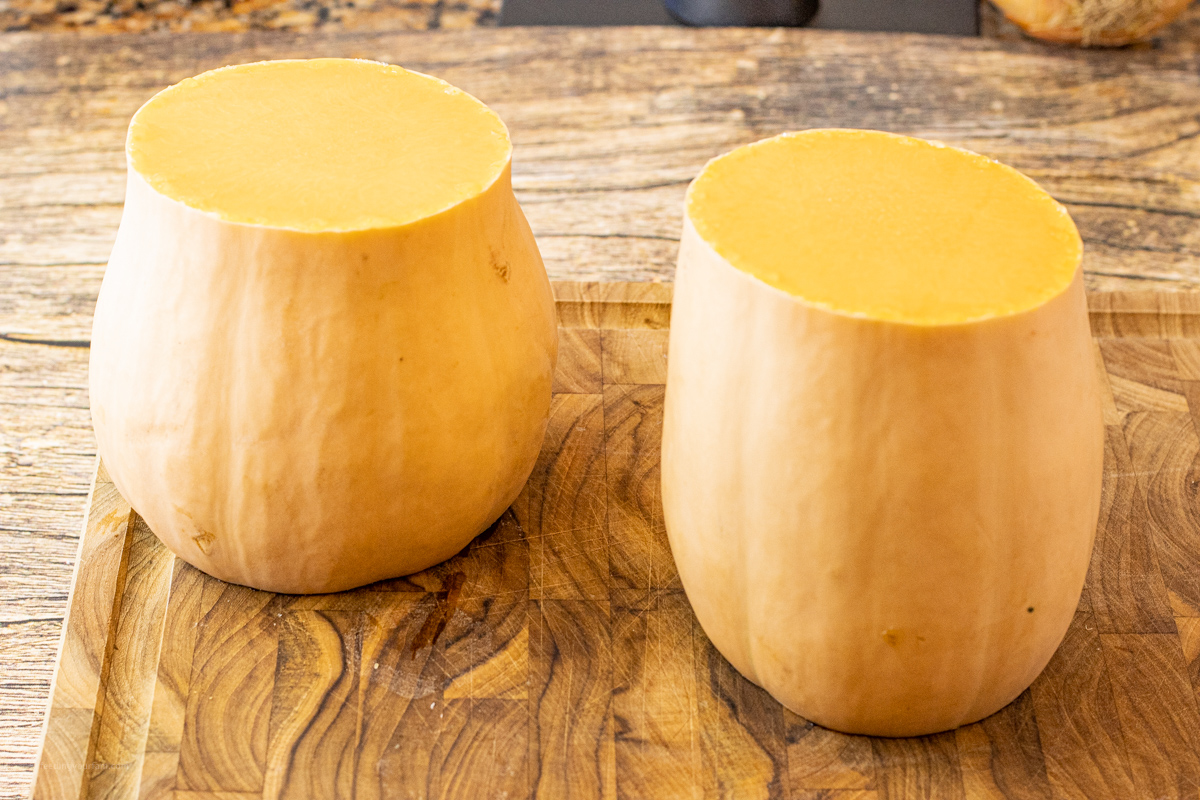 two halves of butternut squash on a cutting board
