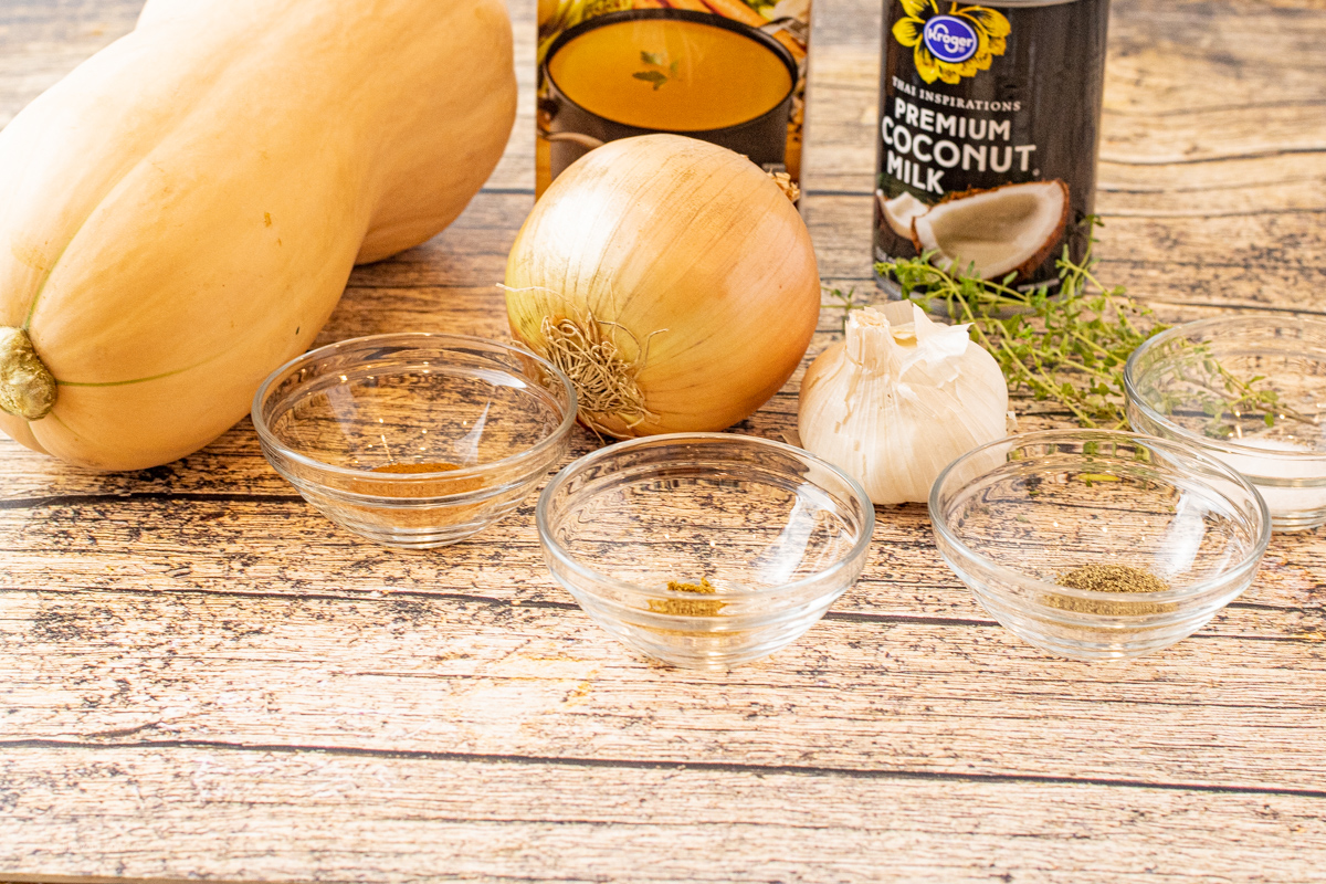 ingredients for butternut squash soup in bowls and cans