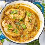 pan with 3 chicken breasts in a creamy tomato sauce