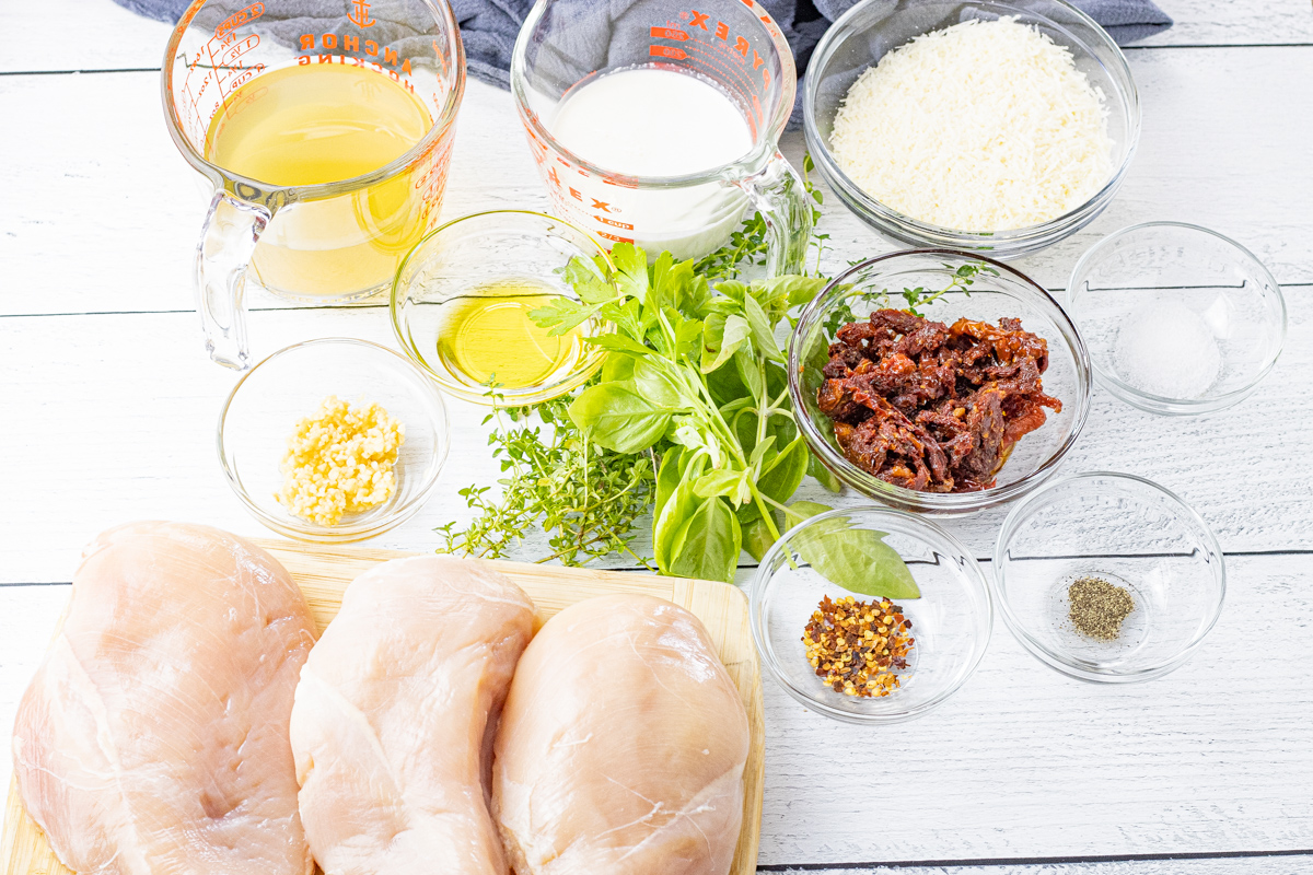 ingredients for chicken in a creamy tomato sauce in little bowls