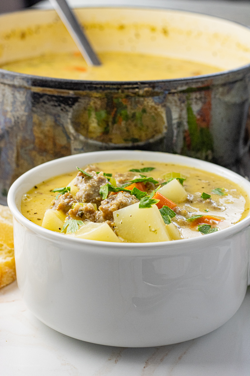 Sausage Potato Soup is so easy to make, creamy and delicious. This Potato and Sausage Soup is loaded with Italian sausage, simple vegetables and of course cheese. Perfect for a busy weeknight meal or when you need a full belly of comfort food!