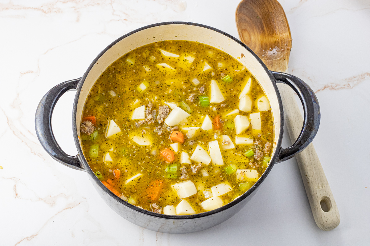 potato and sausage soup in a big black pot