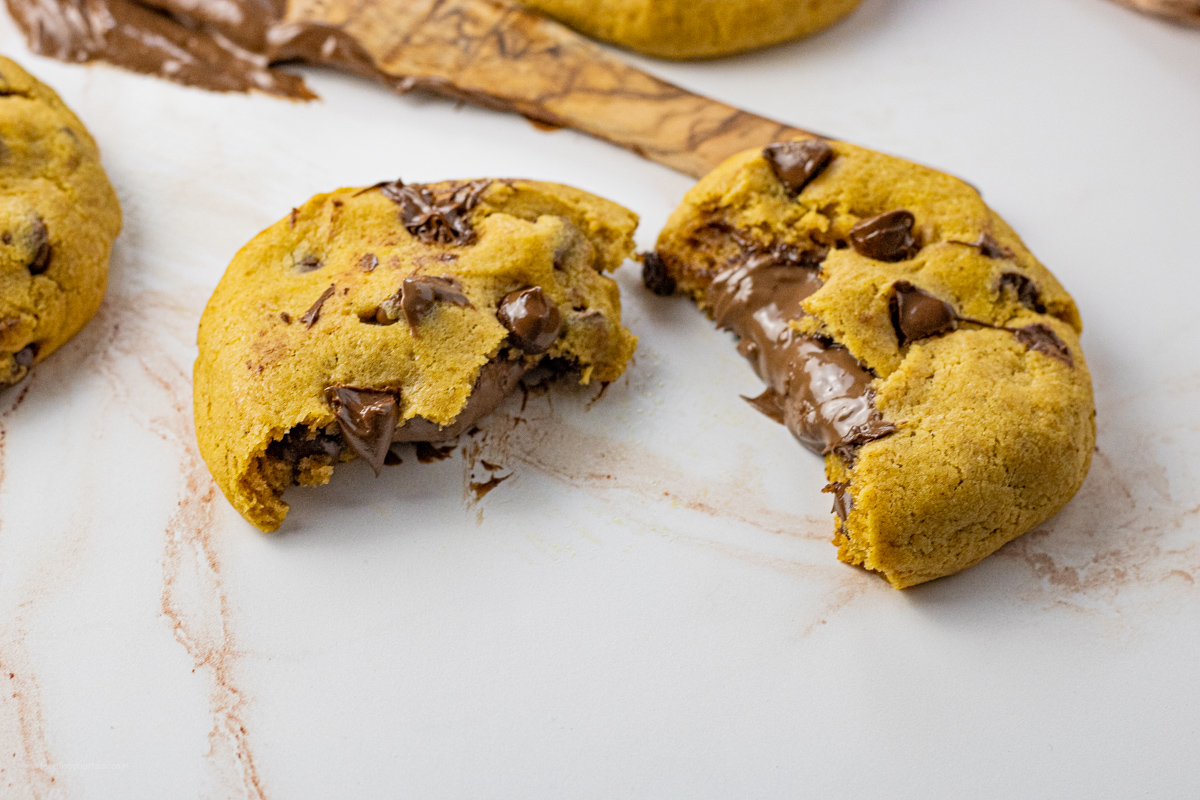 chocolate stuffed pumpkin cookies broken in half