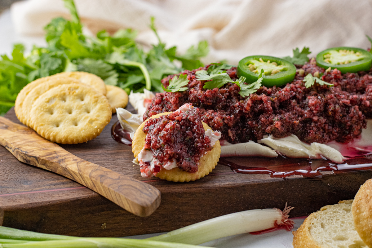 ritz cracker topped with cream cheese and cranberry sauce