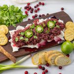 sliced jalapenos on top of cranberry salsa