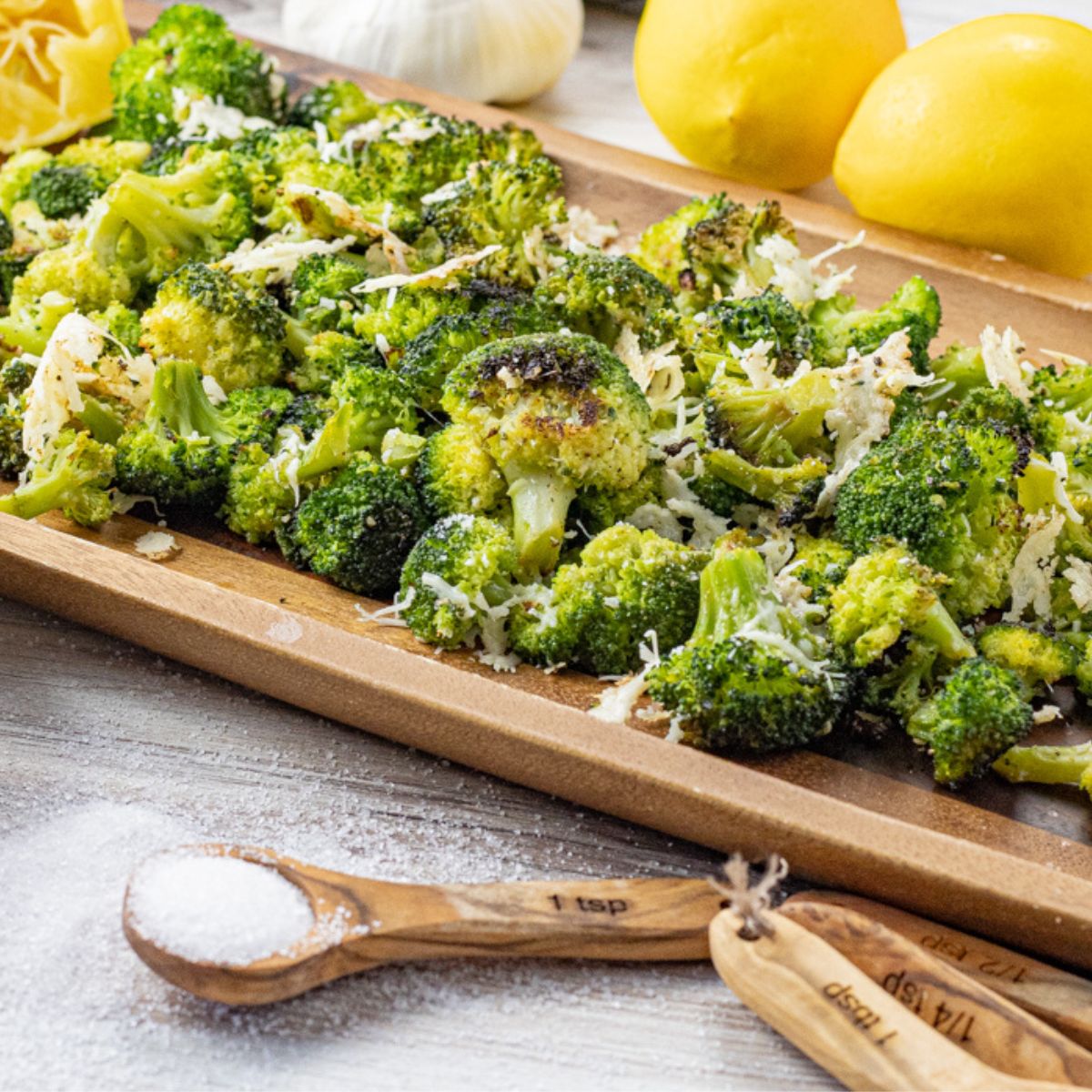 roasted broccoli on a wooden platter