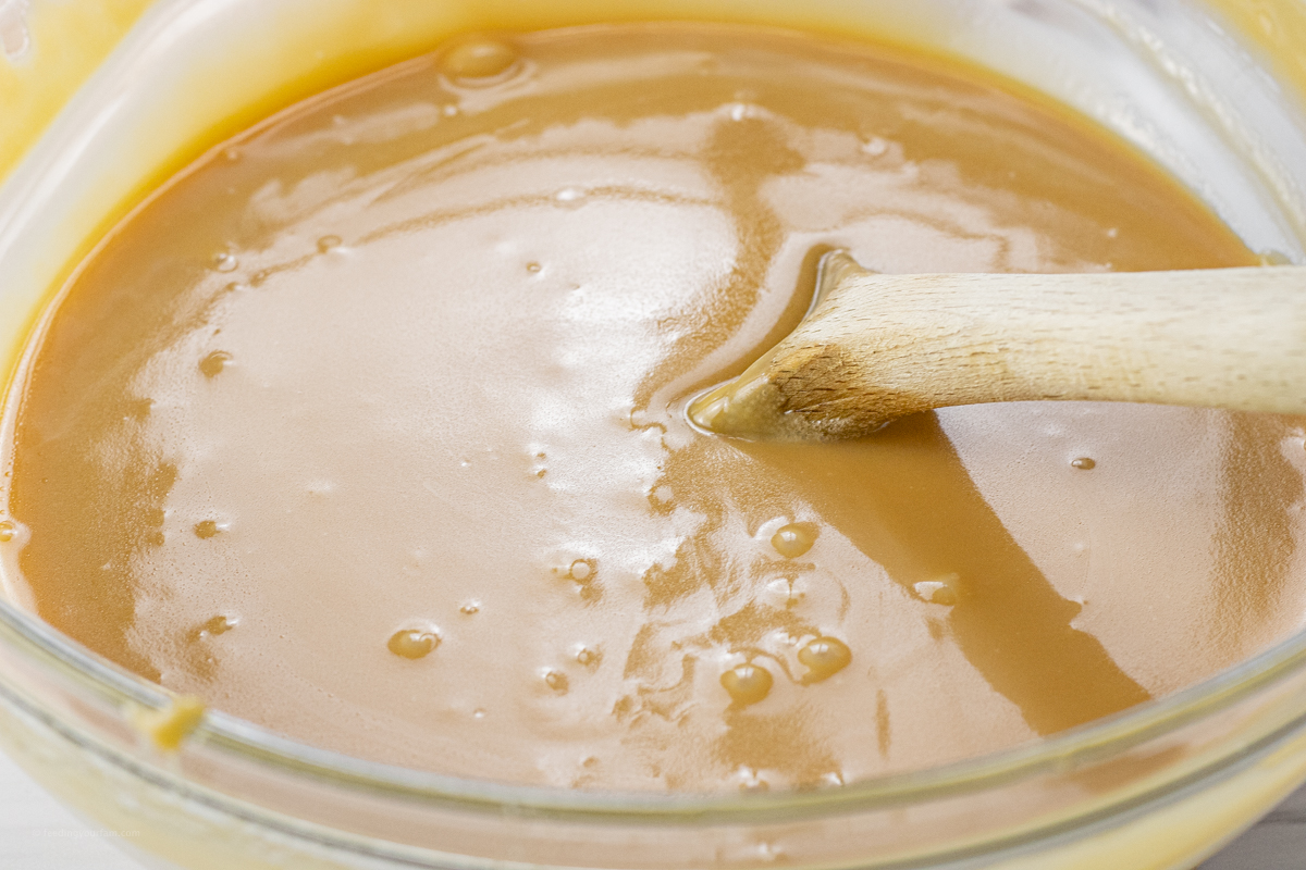 big bowl of caramel with a wooden spoon