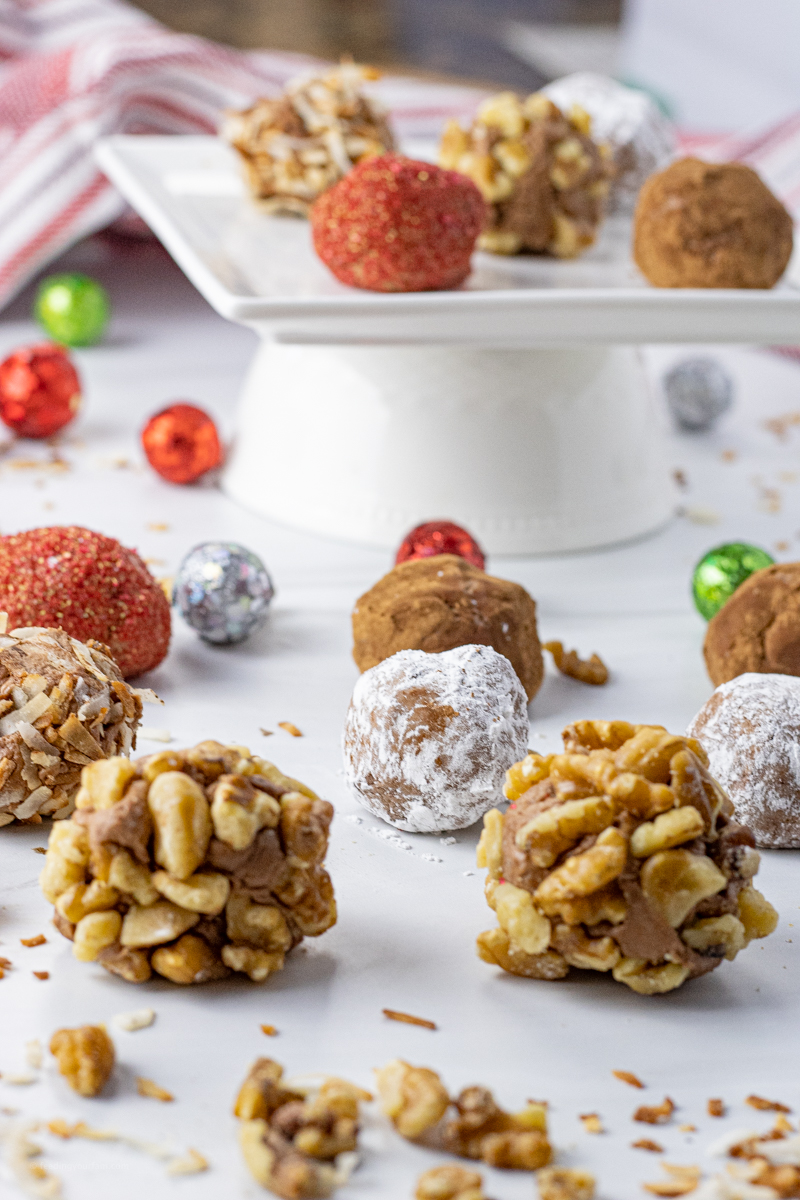 small chocolate balls coated in walnuts, powdered sugar and coconut
