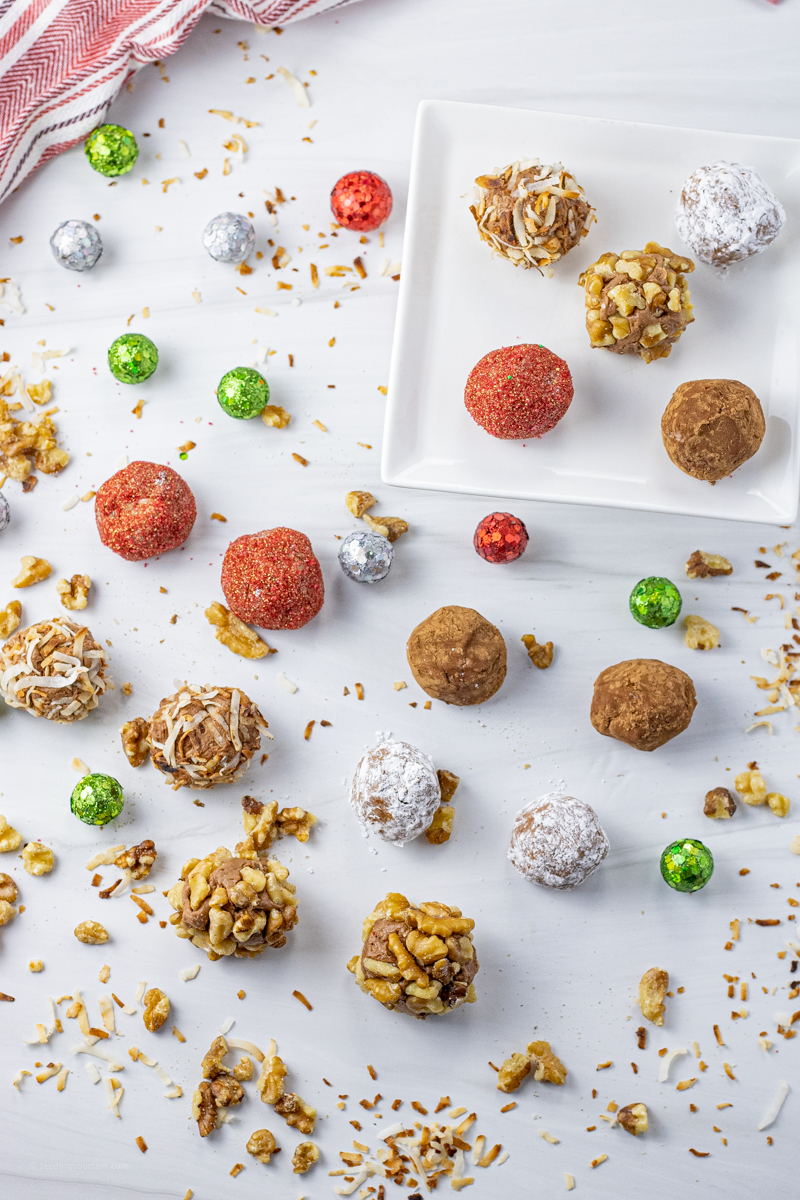 chocolate truffles spread out on a white background
