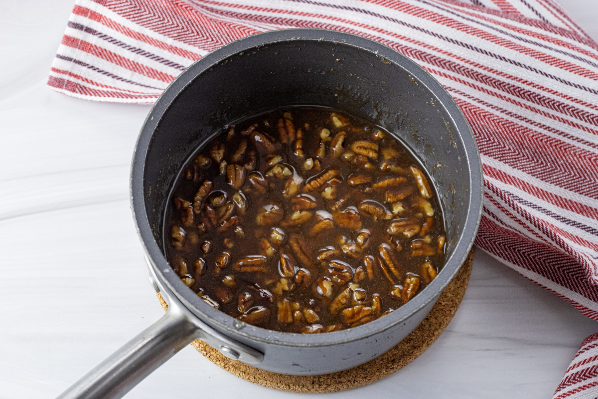 caramel pecan sauce in a saucepan