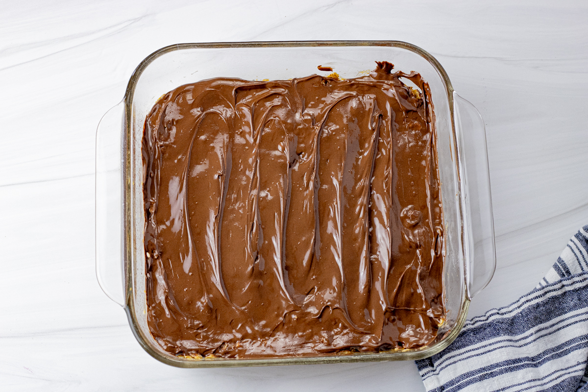chocolate coated granola bars in an 8 x 8 glass pan