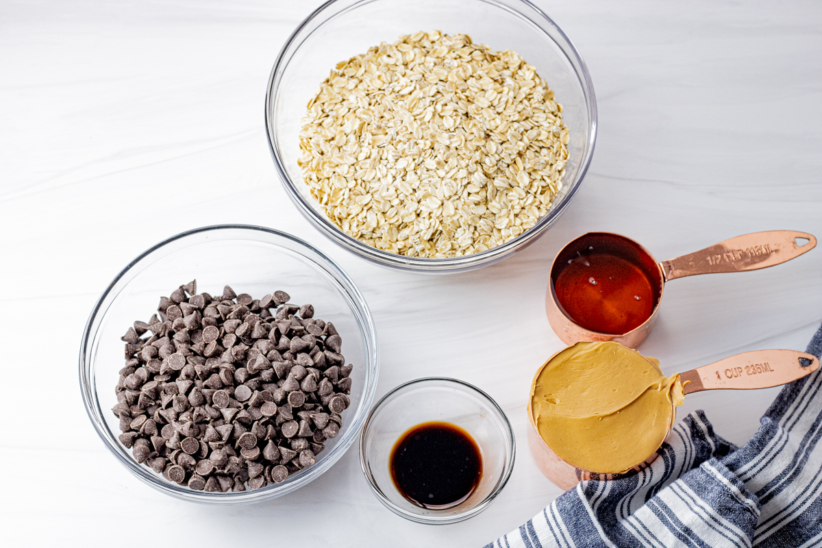 small bowls with oatmeal, honey, peanut butter, vanilla and chocolate chips