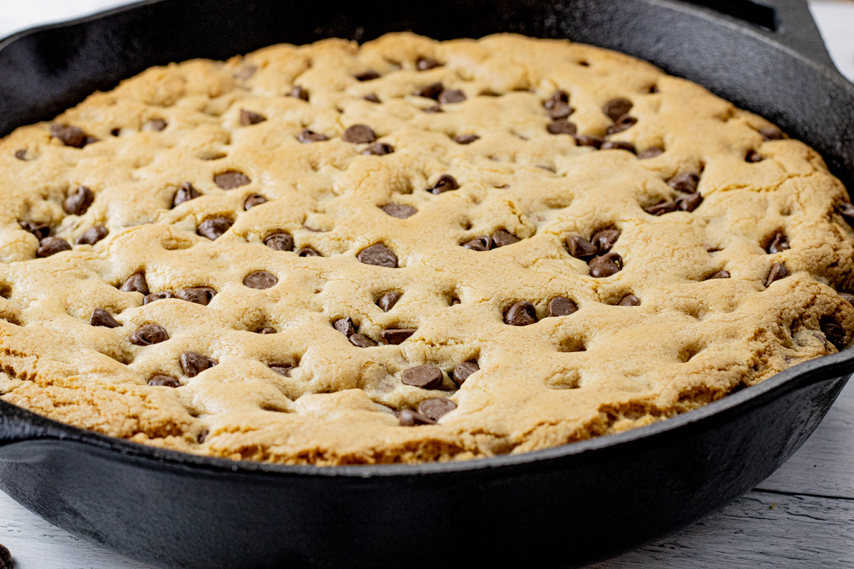 cooked chocolate chip cookie in a cast iron skillet