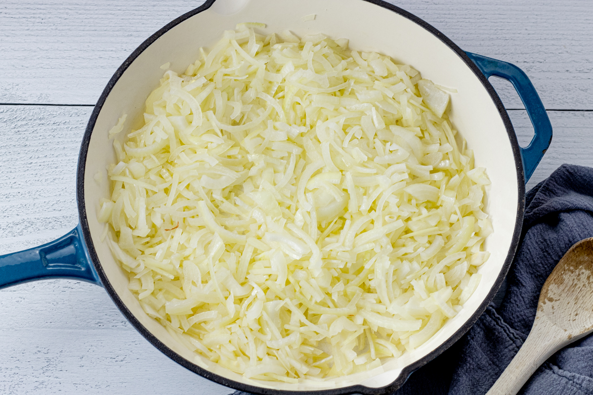 blue pan filled with sliced yellow onions