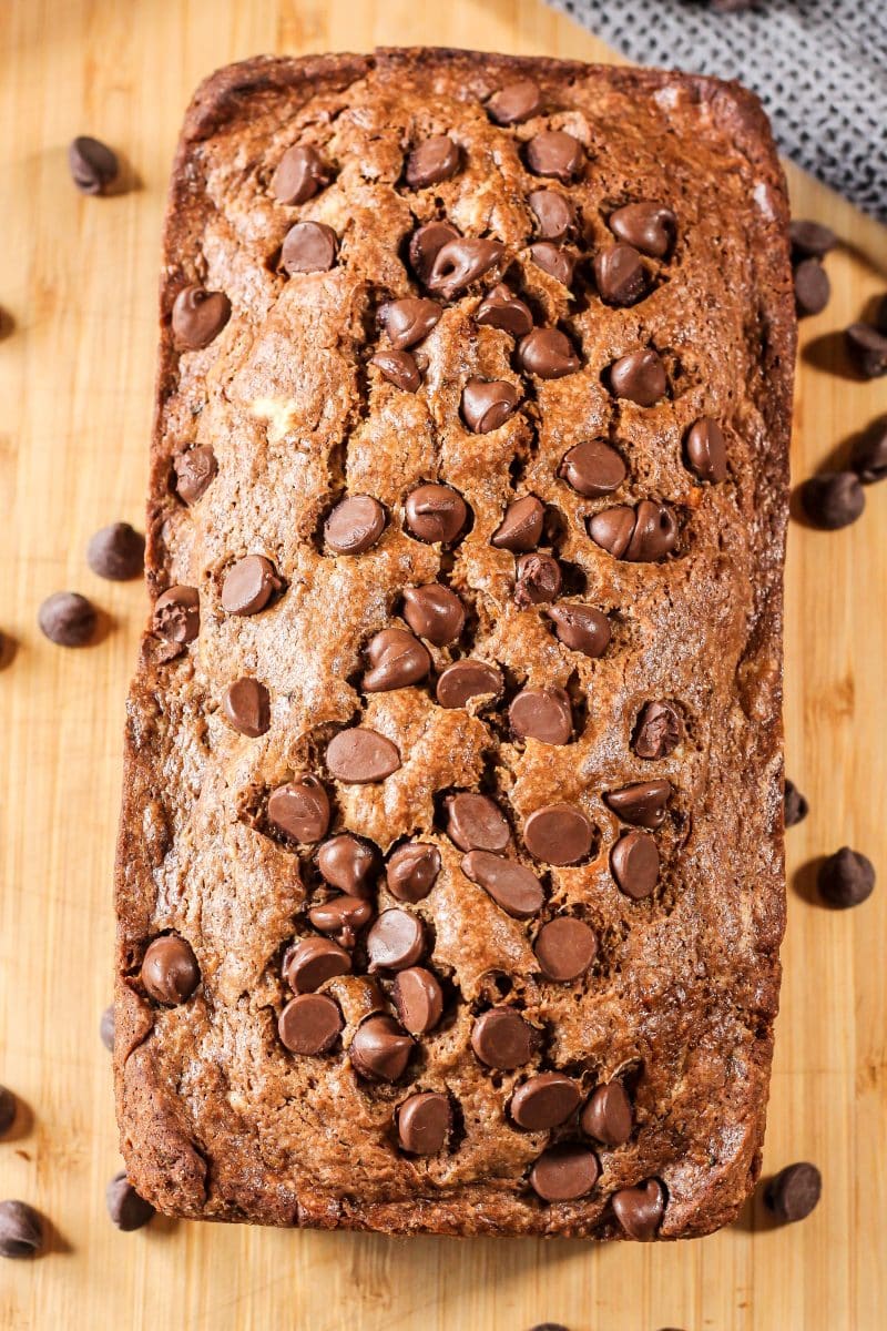 Chocolate Zucchini Bread is a simple bread recipe loaded with delicious chocolate flavor and loaded with healthy zucchini! All you can taste is chocolate goodness with this recipe, you won't even know the zucchini is there! #zucchinibread #zucchinirecipes #zucchini #chocolatezucchini #sweetbread zucchini bread with chocolate chips on top