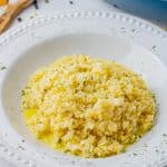 cauliflower rice with cheesy sauce in a white bowl
