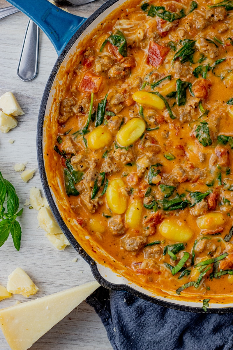 gnocchi in a cream sauce with sausage, tomatoes and spinach