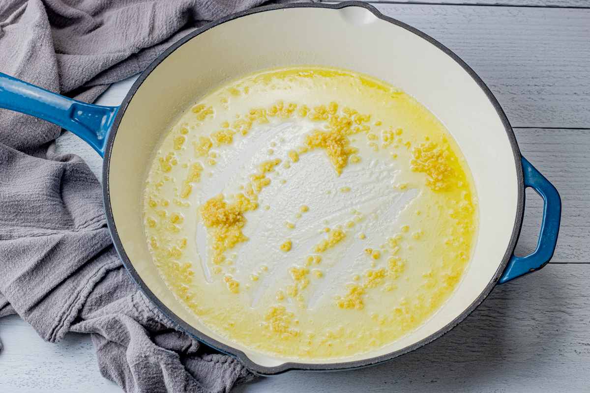 enameled cast iron pan with olive oil, butter and garlic