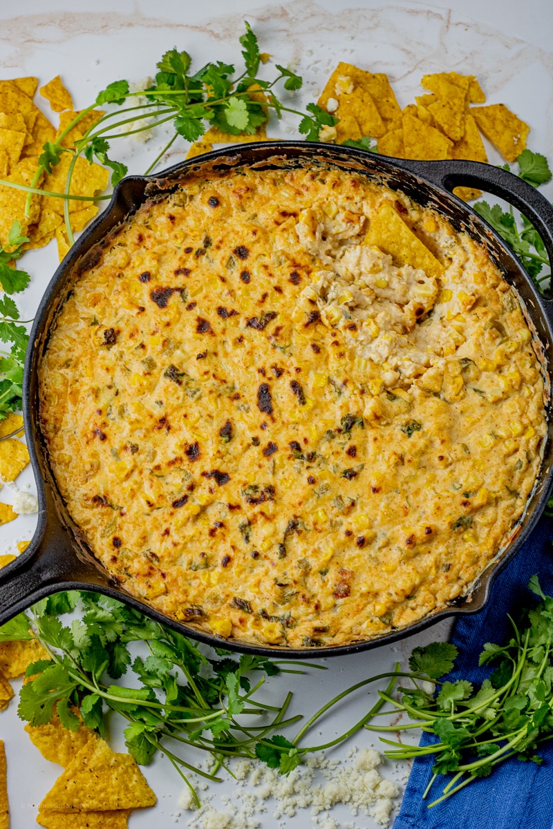 cast iron pan filled with a cheesy corn dip