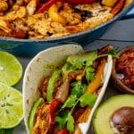 close up image of a chicken fajita wrapped in a flour tortilla