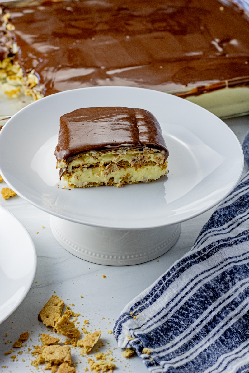 slice of layered cake with graham crackers, vanilla pudding and chocolate frosting