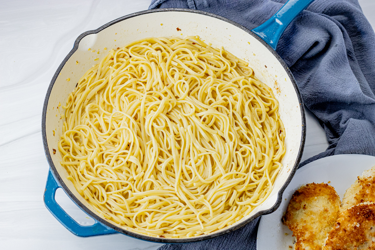 cooked linguine pasta in a cast iron pan