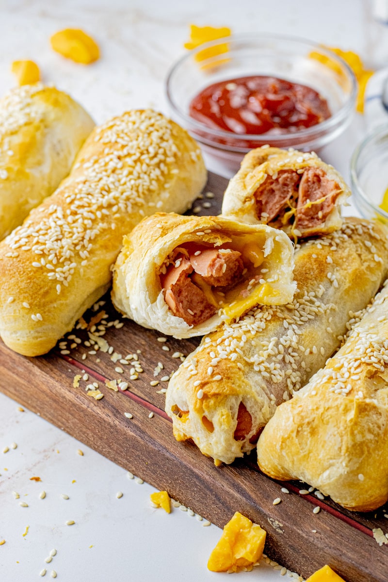 hot dog with cheese wrapped in a biscuit, split in half
