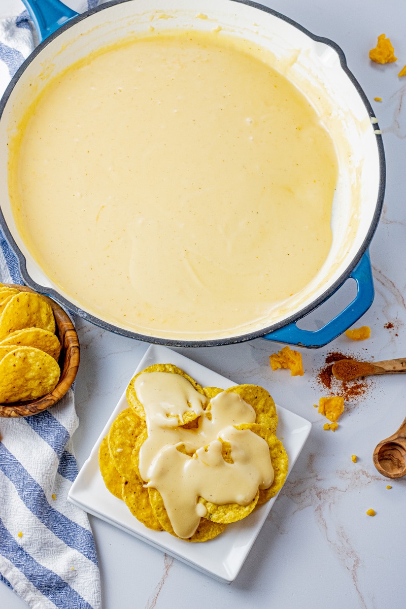 pan of creamy homemade nacho cheese sauce made with cheddar cheese, ready for dipping tortilla chips or pouring over nachos.