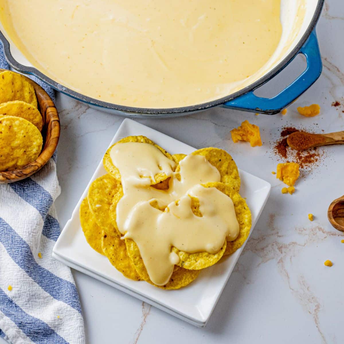 round tortilla chips topped melted nacho cheese