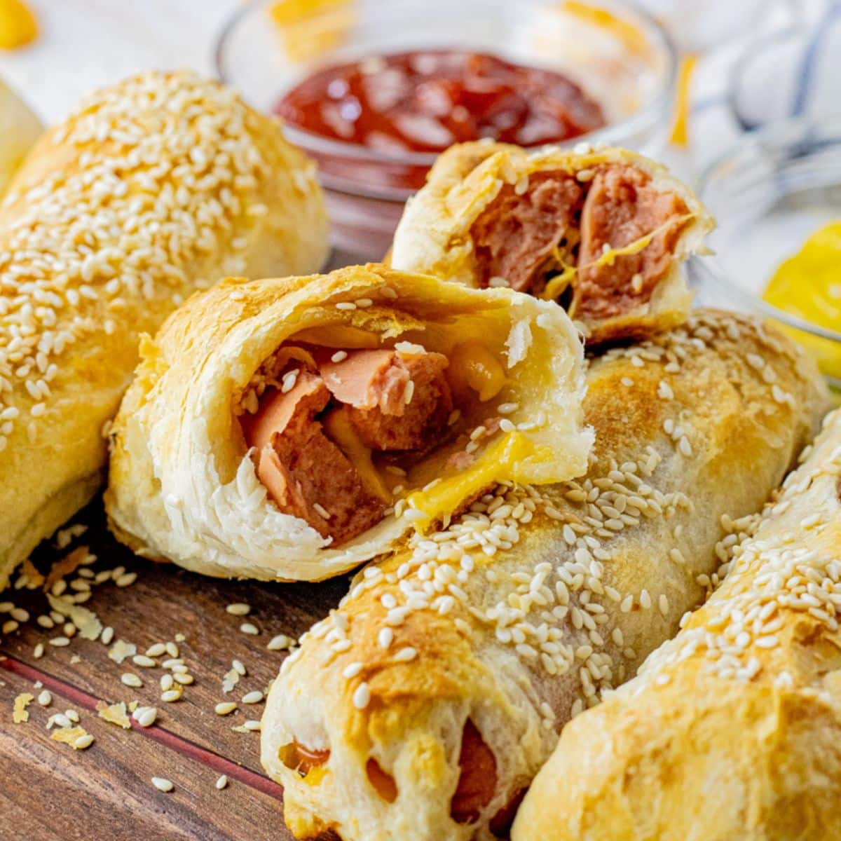 hot dog with cheese wrapped in a biscuit, split in half so you can see the inside