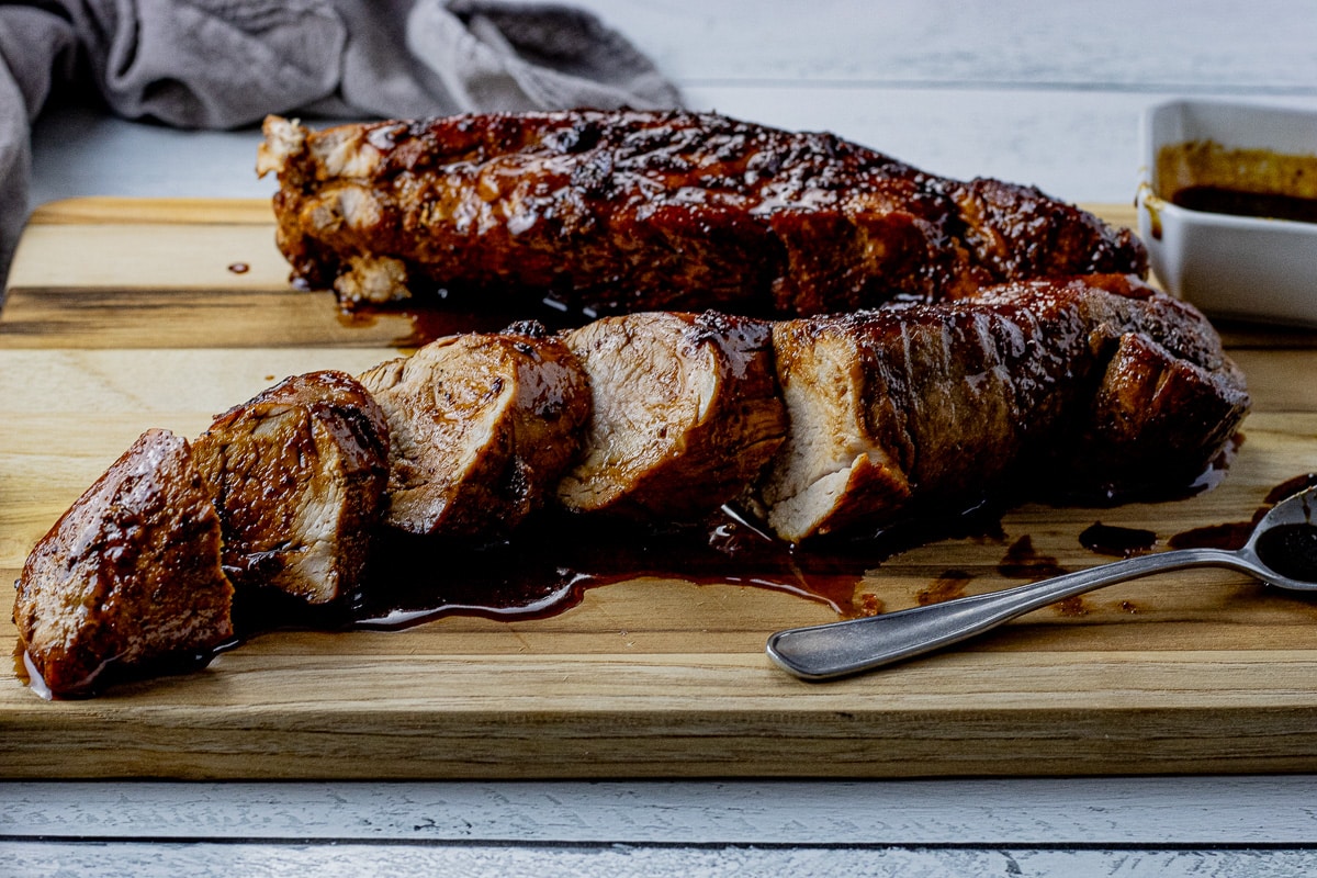sliced pork tenderloin with a maple glaze drizzled over the top